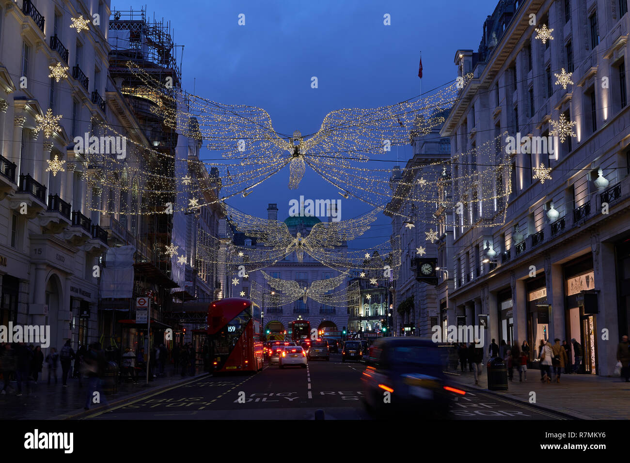 Angel christmas lights hang above shops in St James Regent Street