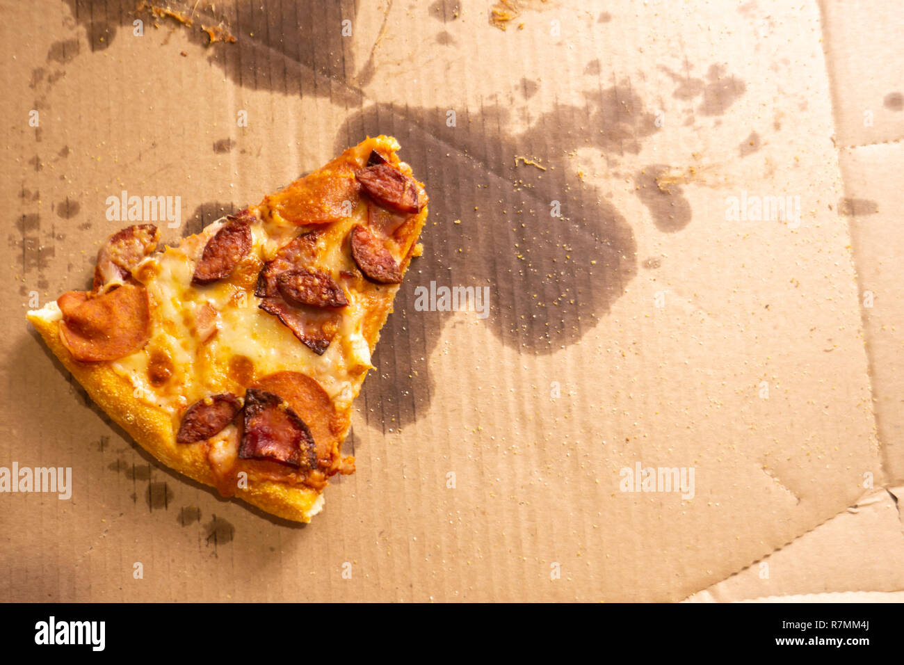 Download A Small Slice Of Pizza Remaining In A Large Cardboard Box With Oil Stains Top View Stock Photo Alamy Yellowimages Mockups