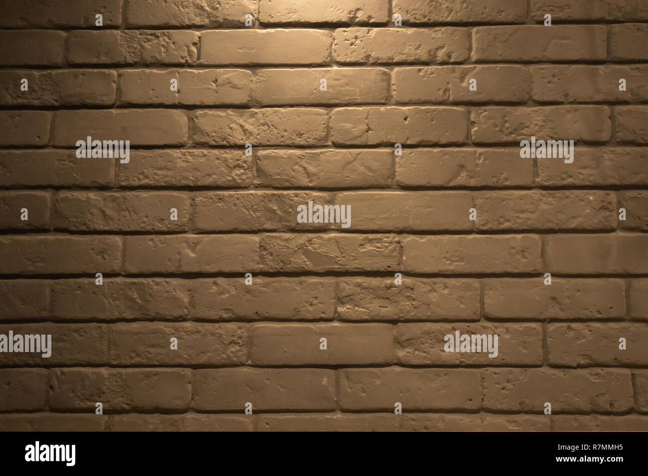 Beautiful gray brick wall, highlighted from above Stock Photo