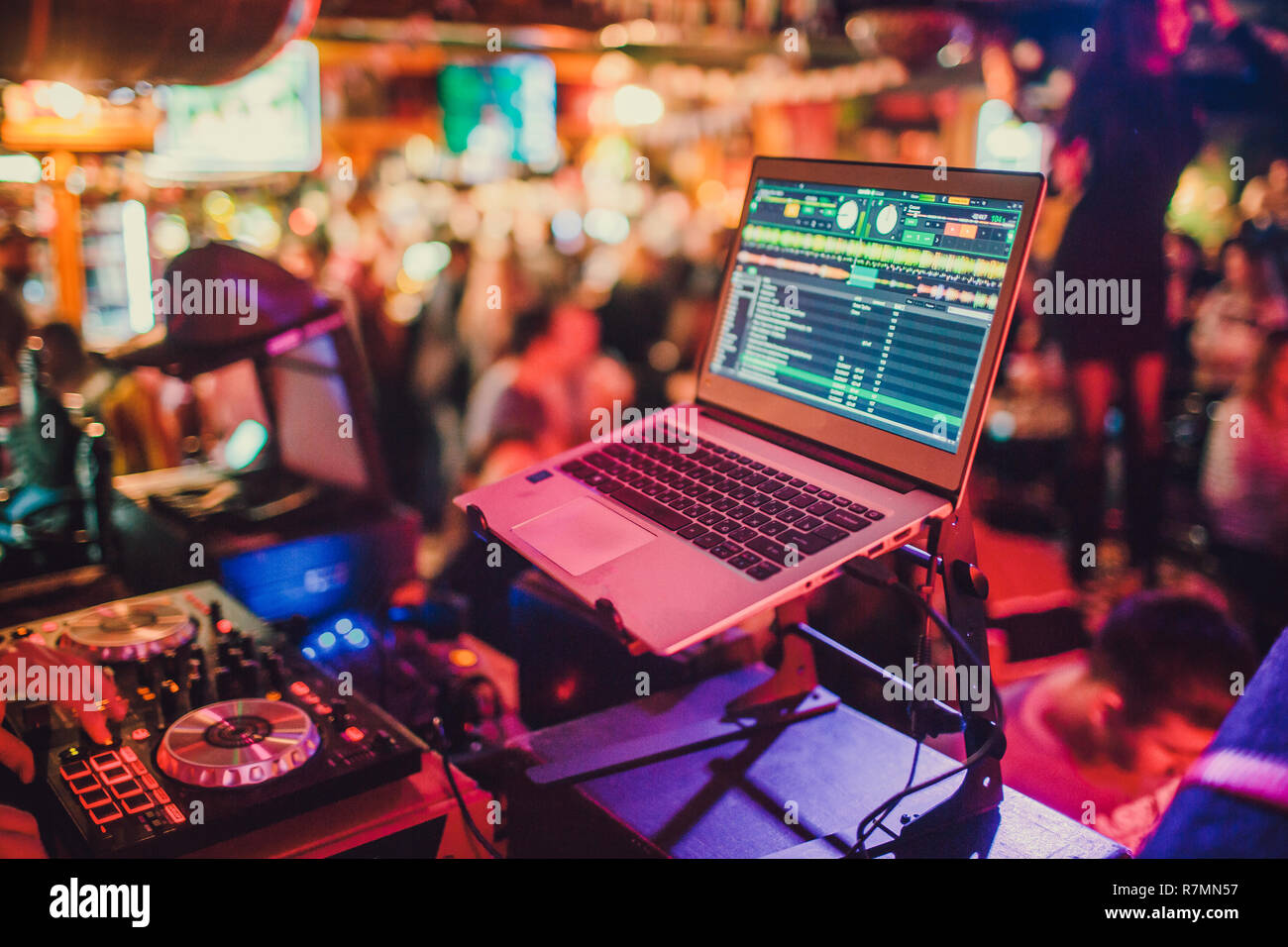 DJ mixing tracks on a mixer in a Stock Photo Alamy