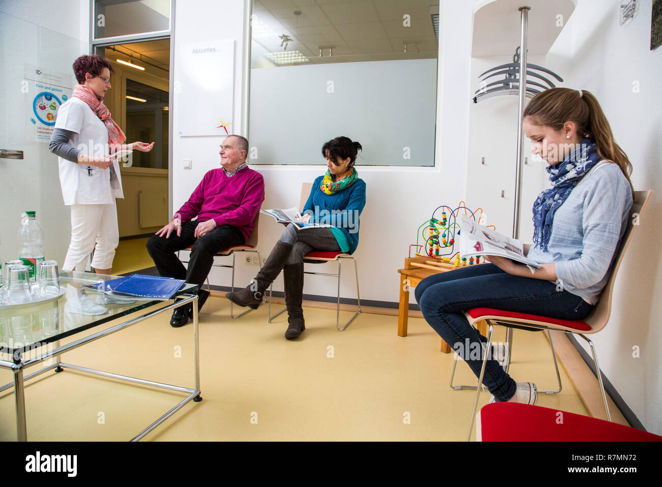 Medical practice, patients waiting in the waiting room, receptionist, Germany Stock Photo
