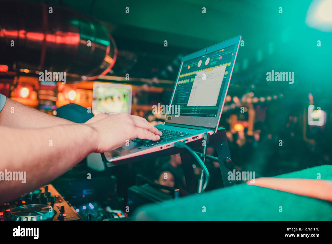 DJ mixing tracks on a mixer in a Stock Photo Alamy