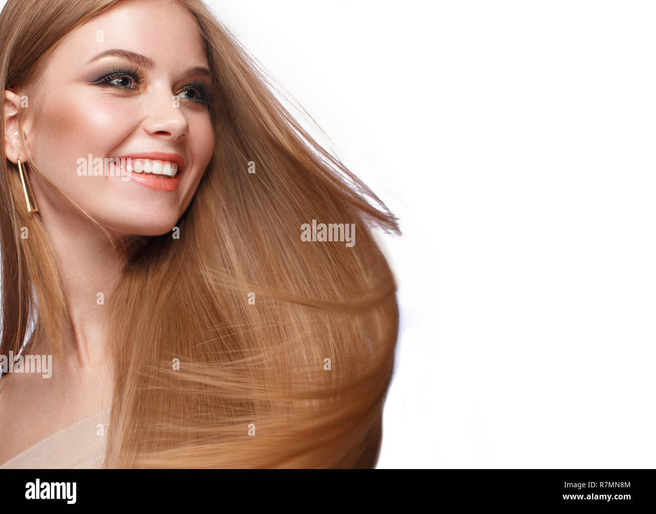 Beautiful blond girl with a perfectly smooth hair, classic make-up. Beauty face Stock Photo