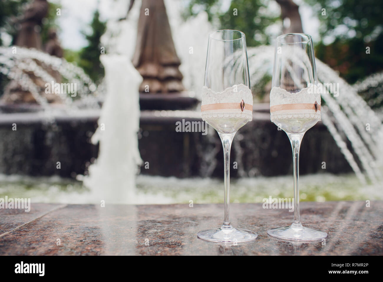 photograph of two glasses with champagne on the background of a