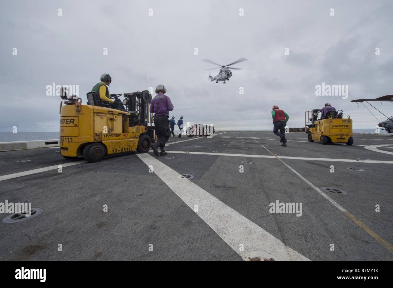 EAST CHINA SEA (March 20, 2017) An SA-330J Puma helicopter, assigned to the Military Sealift Command dry cargo and ammunition ship USNS Richard E. Byrd (T-AKE 4), departs the flight deck of the amphibious transport dock ship USS Green Bay (LPD 20) during a vertical replenishment. Green Bay, part of the Bonhomme Richard Expeditionary Strike Group, with embarked 31st Marine Expeditionary Unit, is on a routine patrol, operating in the Indo-Asia-Pacific region to enhance warfighting readiness and posture forward as a ready-response force for any type of contingency. Stock Photo