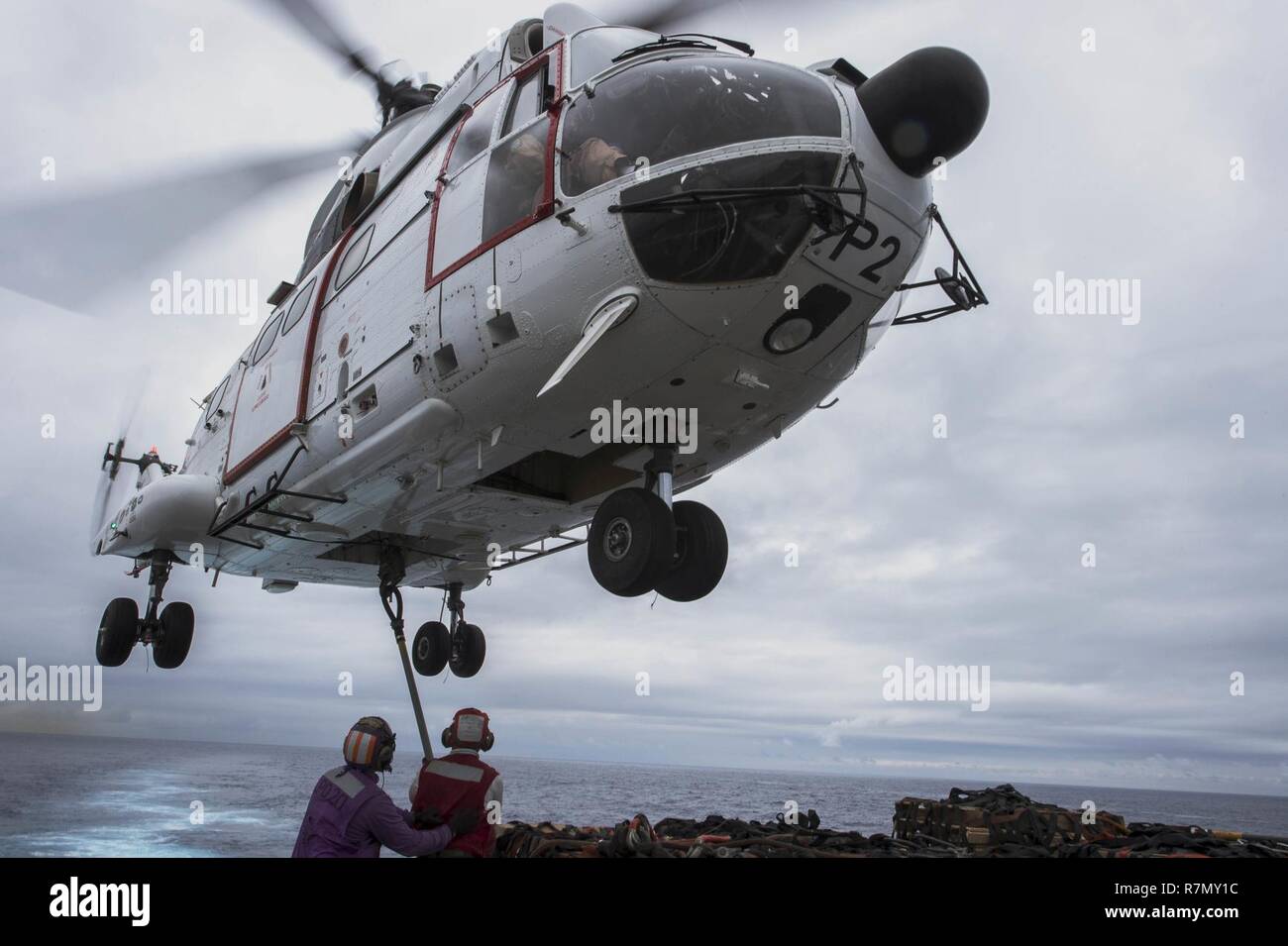 EAST CHINA SEA (March 20, 2017) Sailors attach cargo to an SA-330J Puma helicopter, assigned to the Military Sealift Command dry cargo and ammunition ship USNS Richard E. Byrd (T-AKE 4), on the flight deck of the amphibious transport dock ship USS Green Bay (LPD 20) during a vertical replenishment. Green Bay, part of the Bonhomme Richard Expeditionary Strike Group, with embarked 31st Marine Expeditionary Unit, is on a routine patrol, operating in the Indo-Asia-Pacific region to enhance warfighting readiness and posture forward as a ready-response force for any type of contingency. Stock Photo