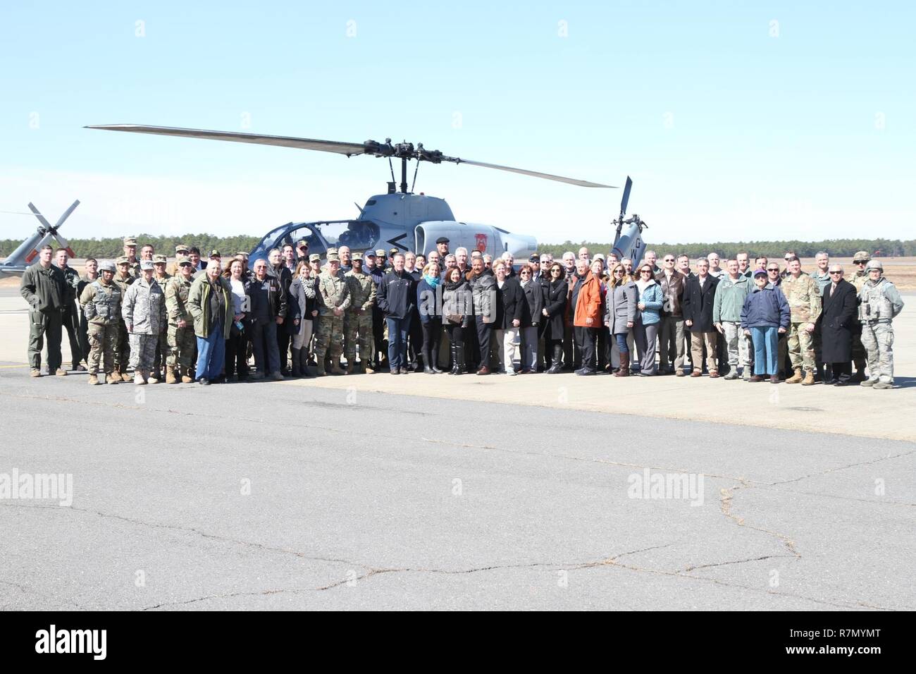 Distinguished Visitors and fellow service members gather for a photo at