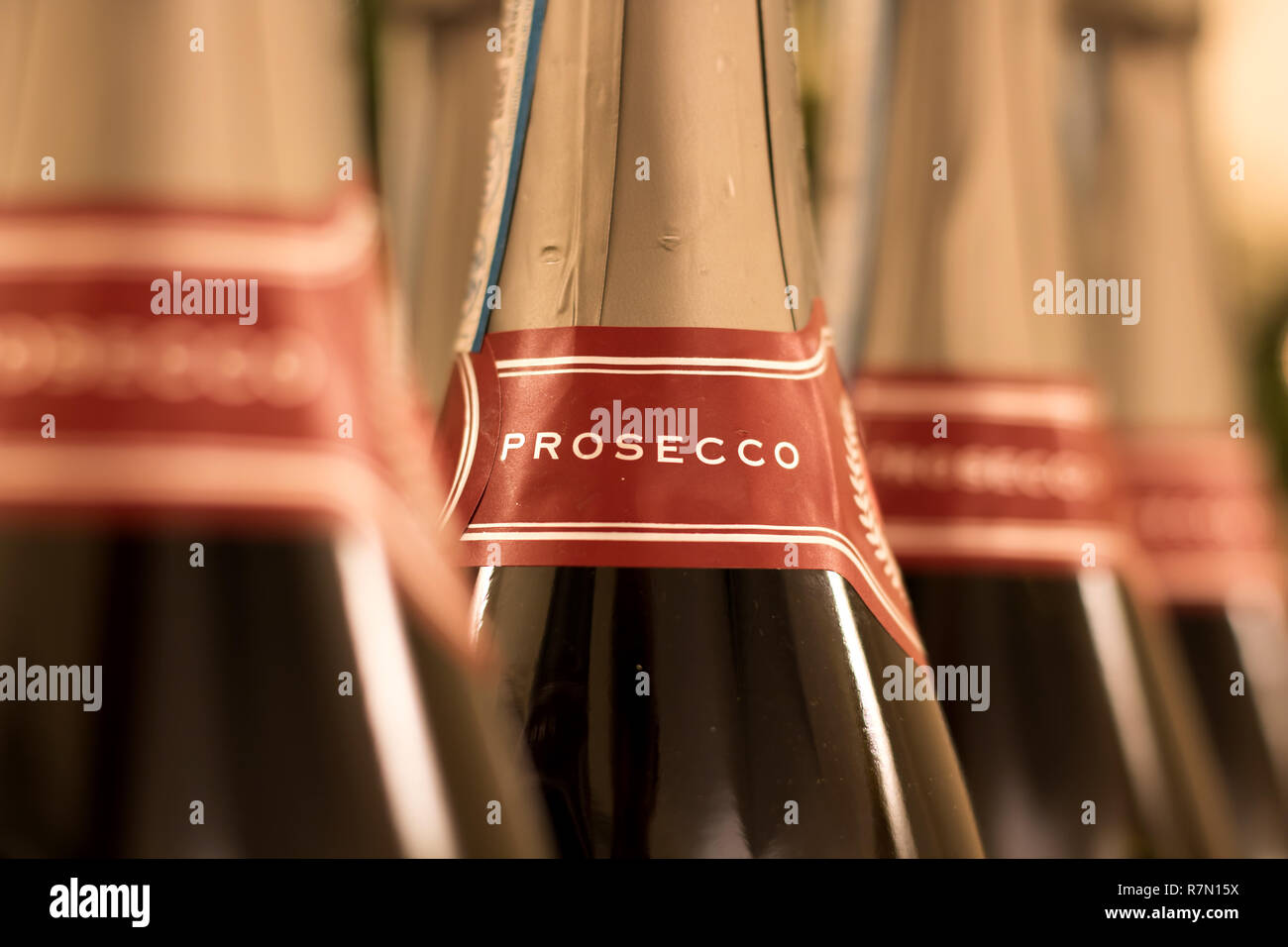 Prosecco bottles in closeup showing label around neck of bottle Stock