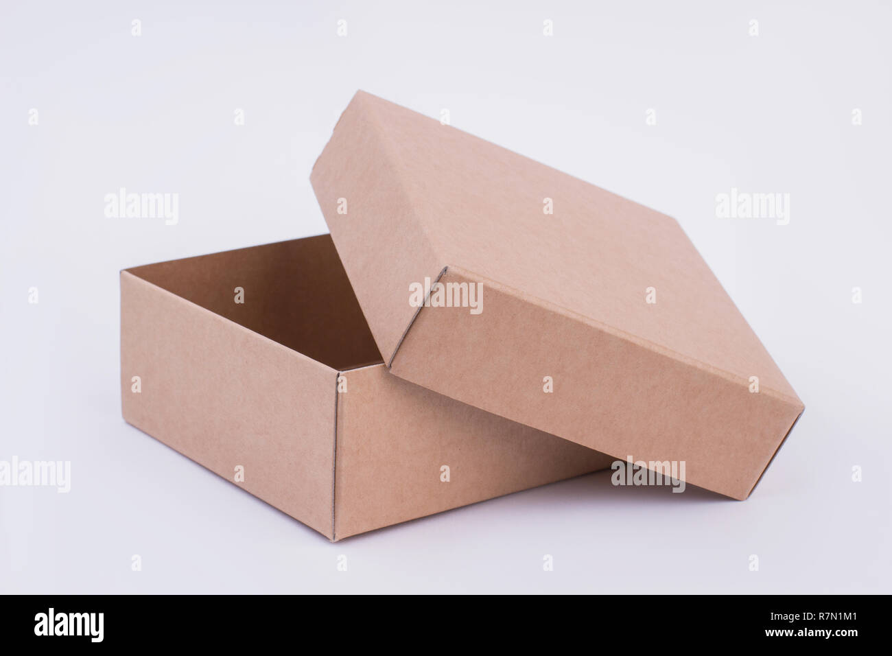 Open beige cardboard box. Blank carton box isolated. Empty paper box