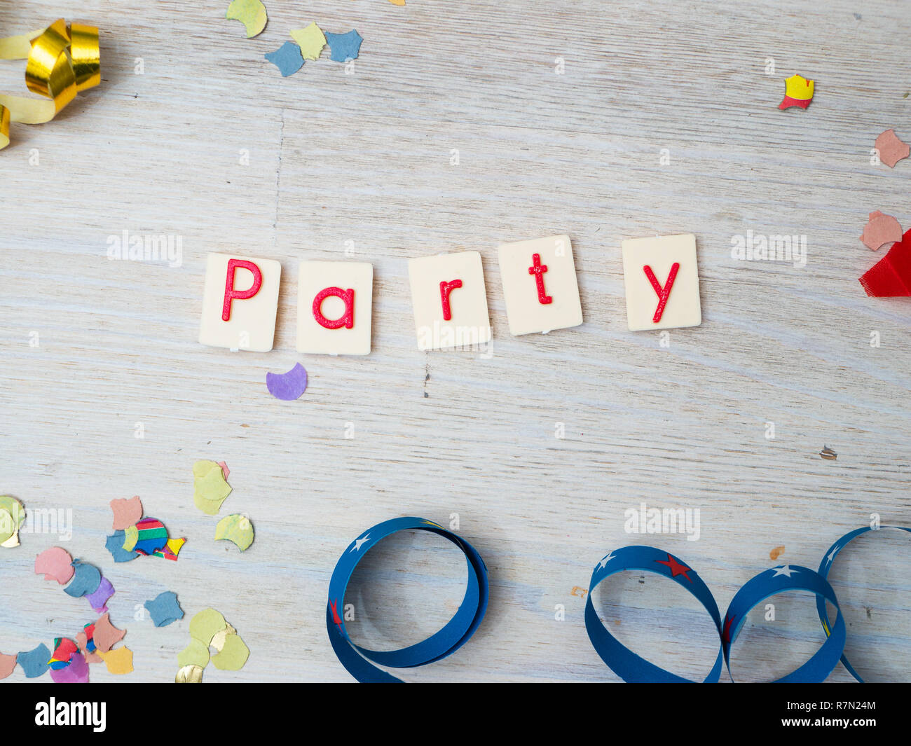 Party Lettering with party decoration on, concept image, wooden background Stock Photo