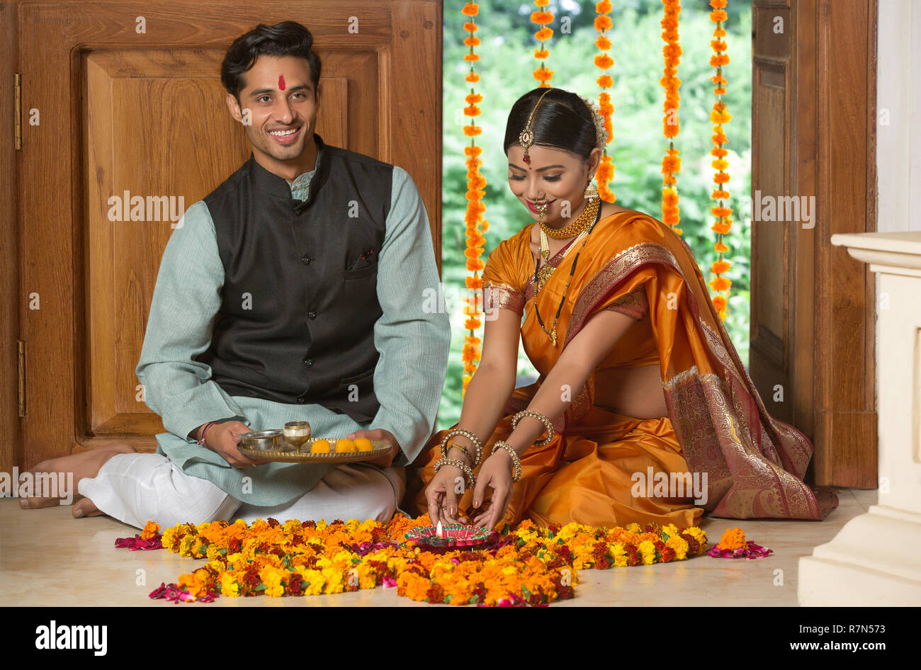 Happy Maharashtrian Couple In Traditional Dress Sitting On The