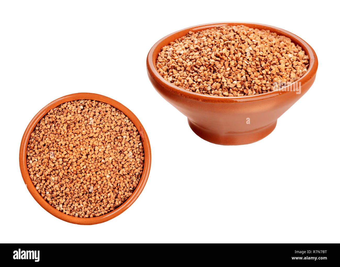 Photos of dry buckwheat in earthenware bowls, angle and overhead views, isolated on a white background Stock Photo
