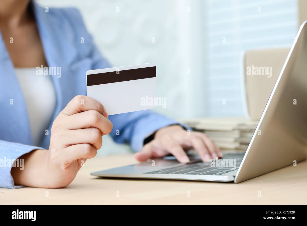 Hand holding credit card typing on the keyboard of laptop for online shopping ecommerce concept Stock Photo