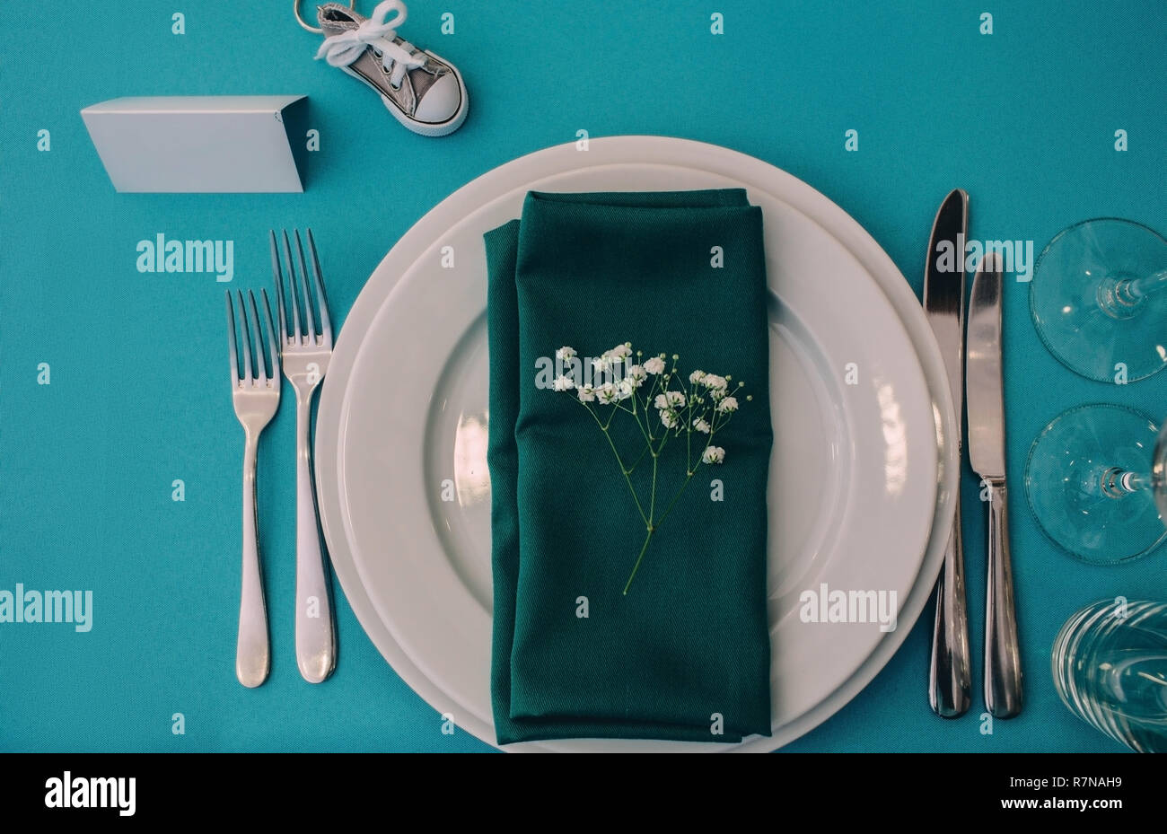 Dinner plate setting on a turquoise table , top view. Stock Photo
