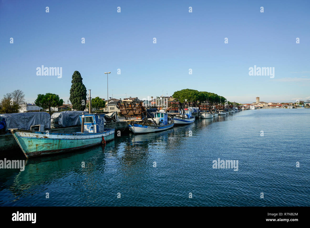 Some fishing boats moored on the pier of the port of Marano Lagunare, Friuli Venezia Giulia Region, Italy Stock Photo