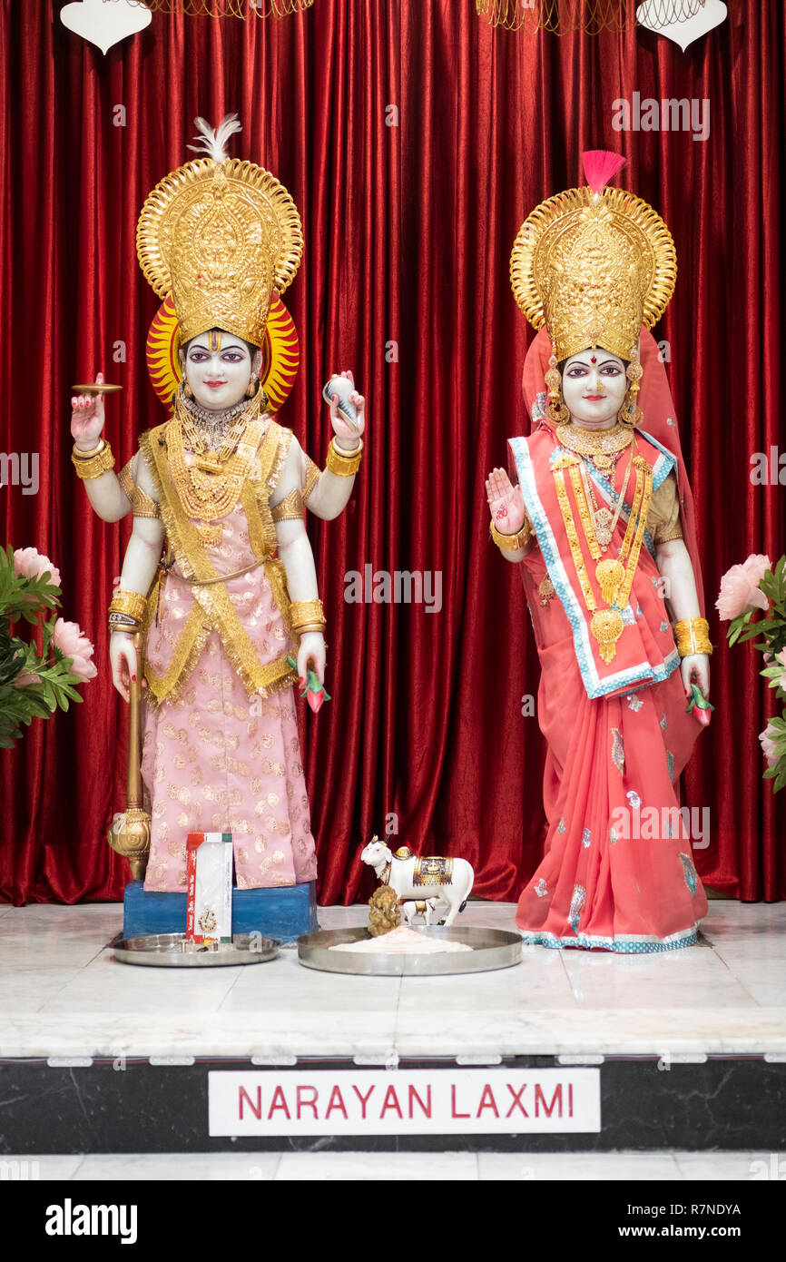 Statues of the deities Narayan and Laxmi at the alter inside the Geeta Temple in Corona, Queens, New York City Stock Photo