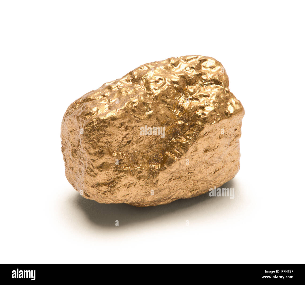Single Gold Nuget Isolated on White Background. Stock Photo