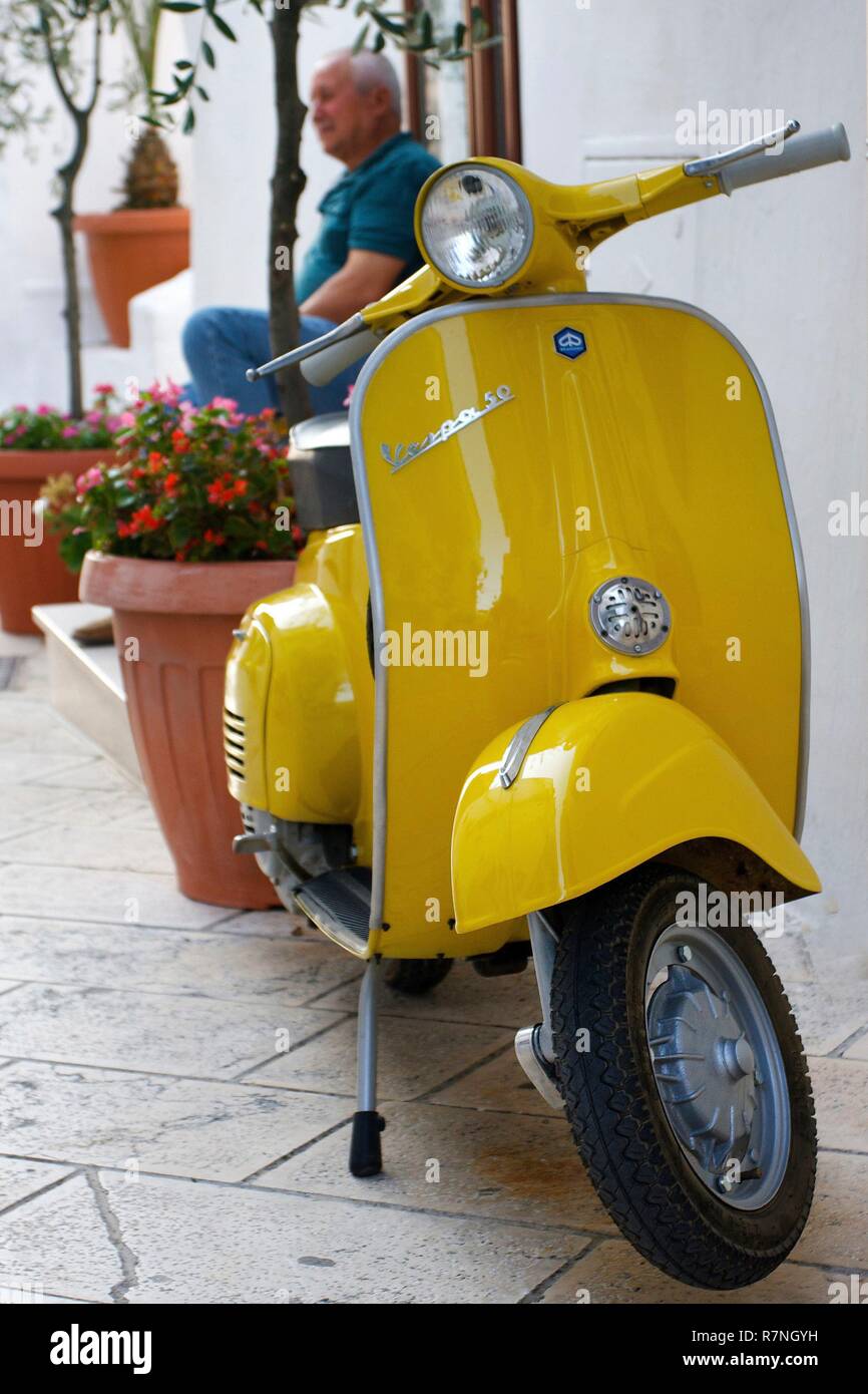 Italy, Puglia, Ostuni, Yellow Vespa in a whith alley Stock Photo