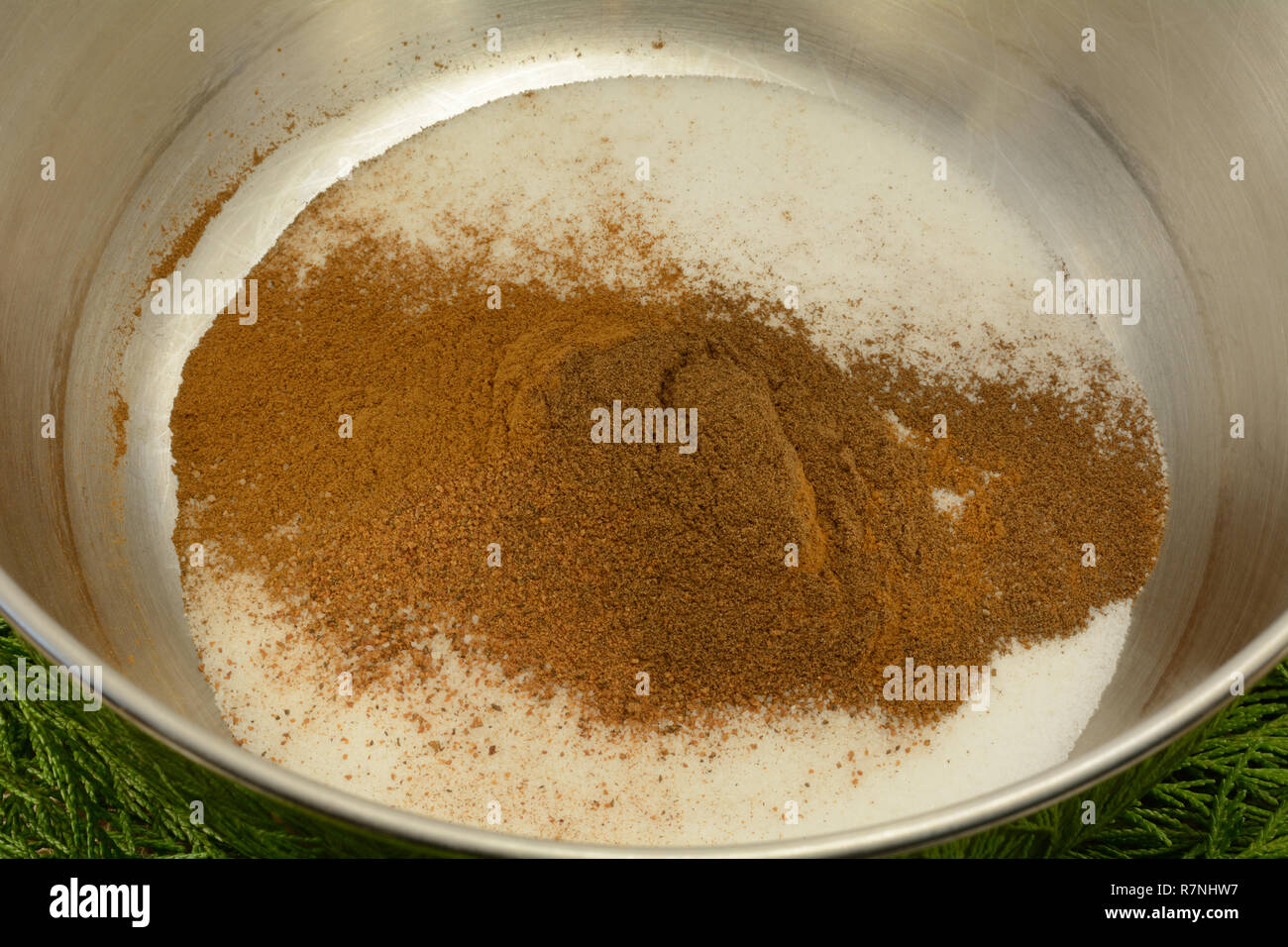Mixing dry ingredients together of sugar, nutmeg, cinnamon and allspice