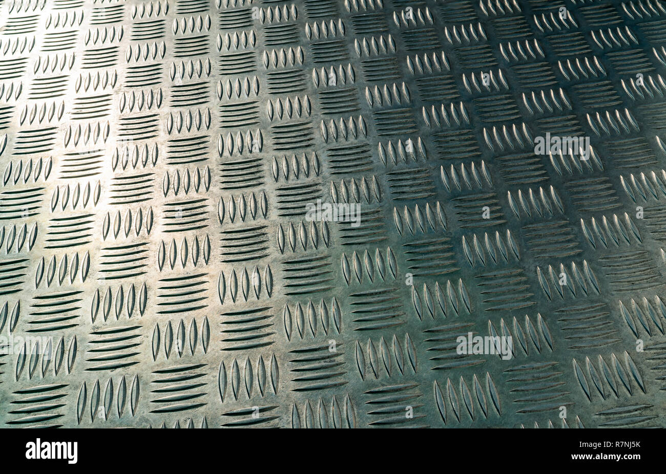 Industrial metal checker plate. Metal checker plate texture background. Metal checkerplate for anti skid. Embossed metal sheet floor. Silver bump grou Stock Photo
