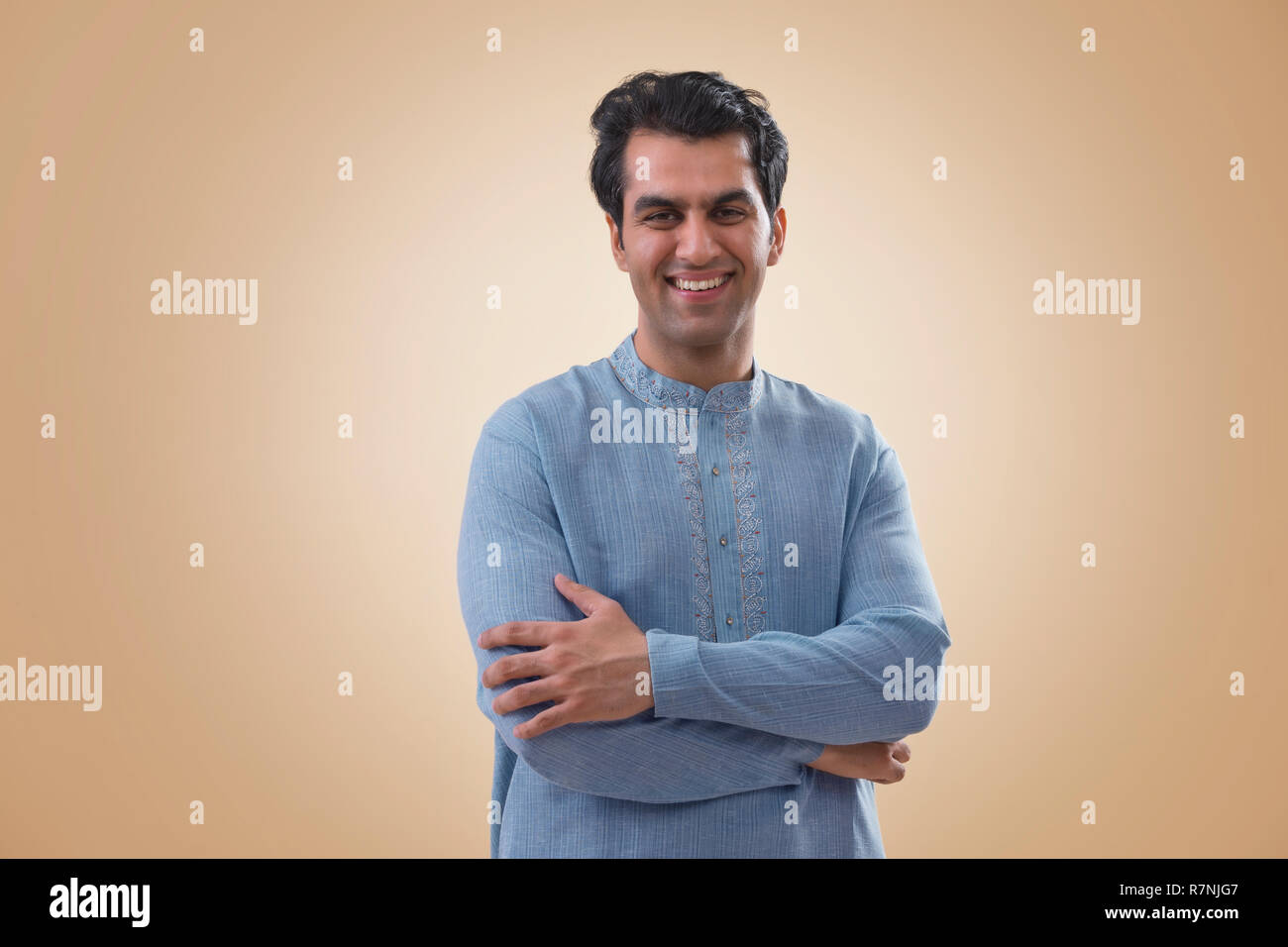 Indian young man standing arms hi-res stock photography and images - Alamy