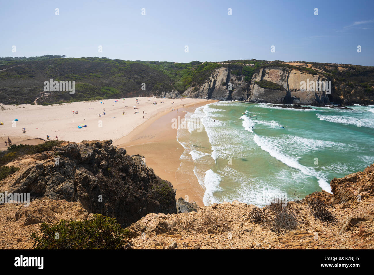 Praia do Carvalhal with breaking Atlantic waves in the afternoon sun, Zambujeira do Mar, Alentejo region, Portugal, Europe Stock Photo