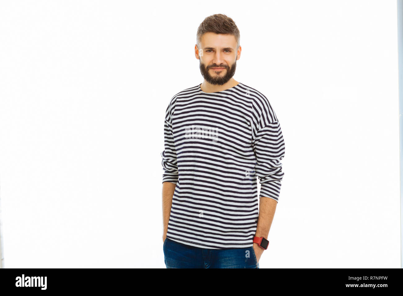 Handsome bearded young man smiling to you Stock Photo