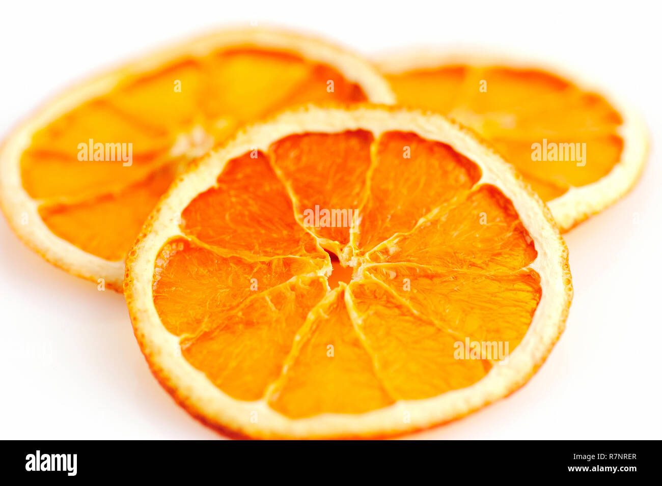 Three dried orange slices from above on white background Stock Photo