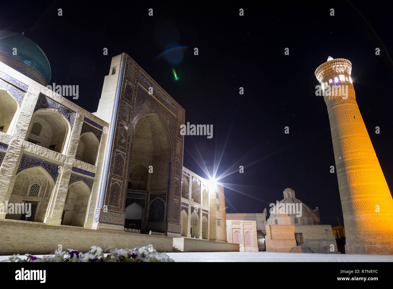 Night photo shoot of ancient buildings in the old town of Bukhara, Central Asia. Kalyan minaret of Poi Kalyan the Islamic religious complex in Bukhara Stock Photo
