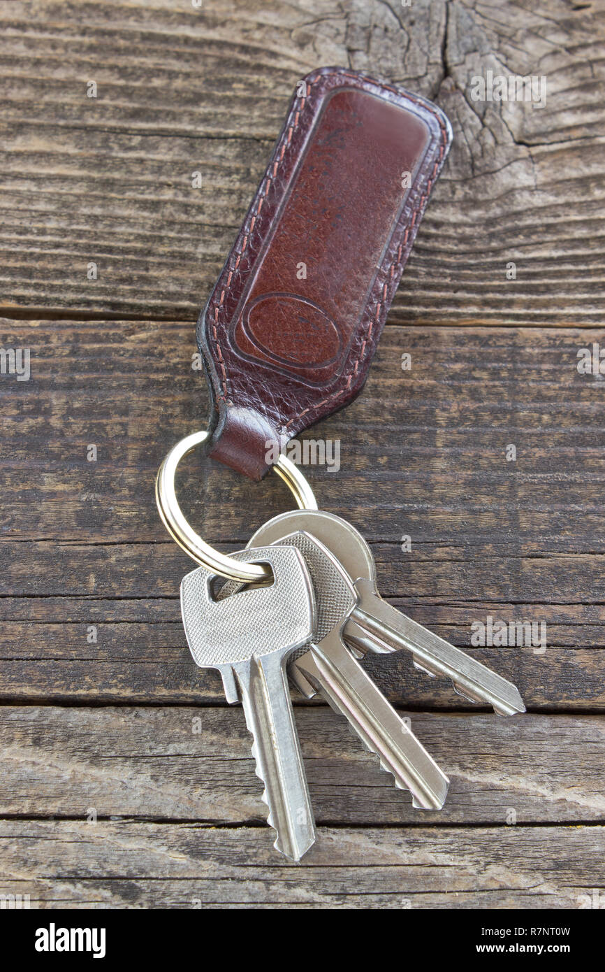 Keys with leather tag on wooden background Stock Photo