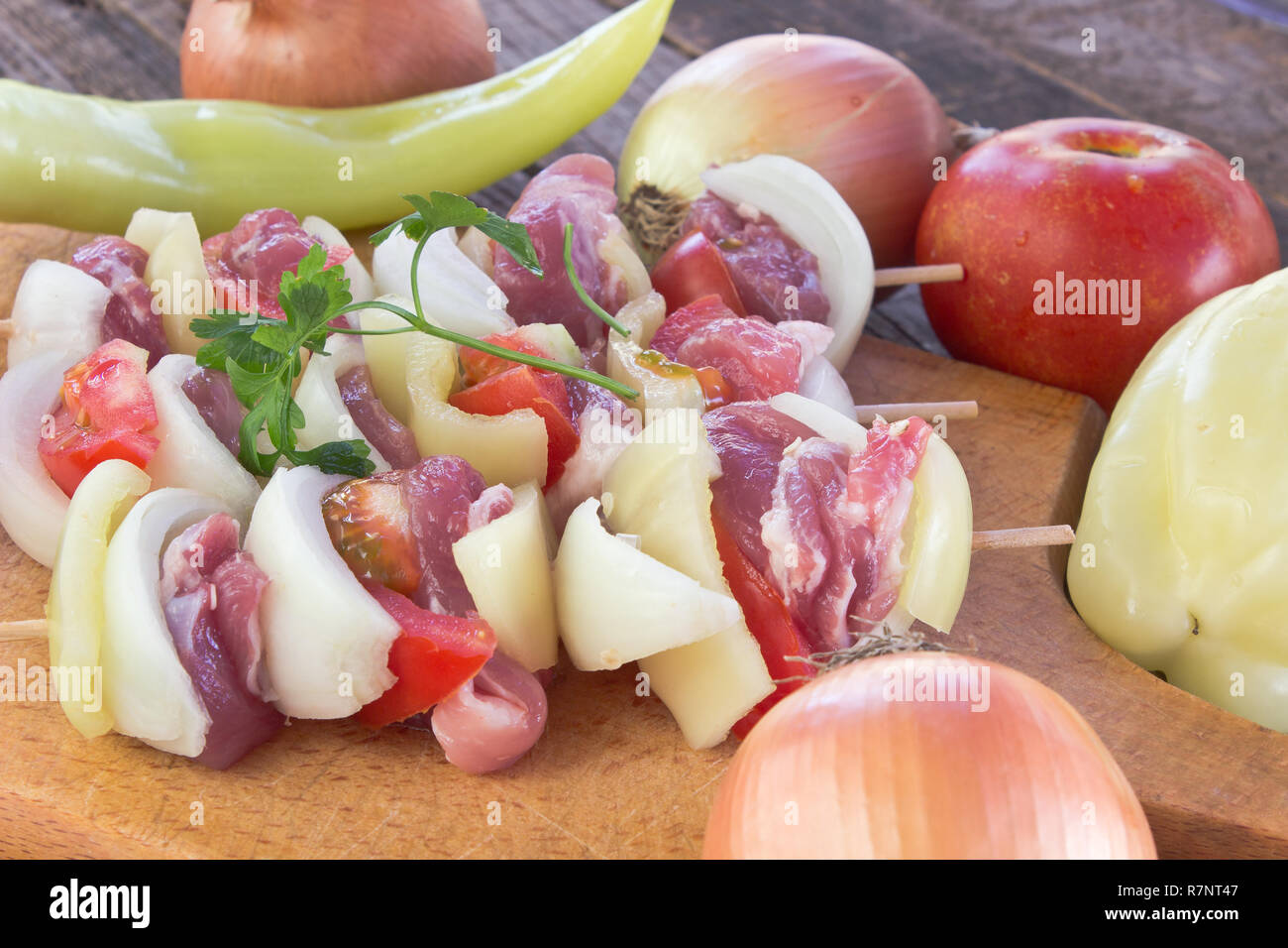 Raw meat for grill with vegetables on cutting board Stock Photo