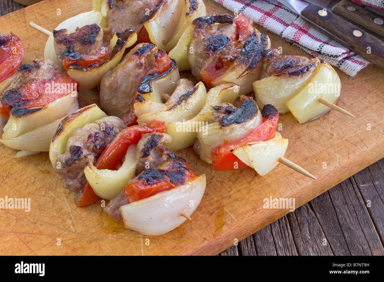 Grilled meat with vegetables on cutting board Stock Photo