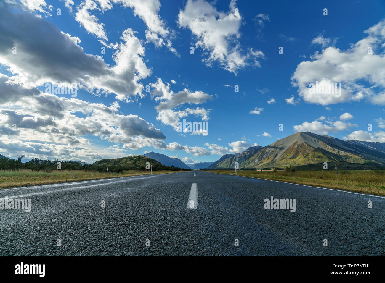 on the road in the valley between mountains, arthurs pass, new zealand