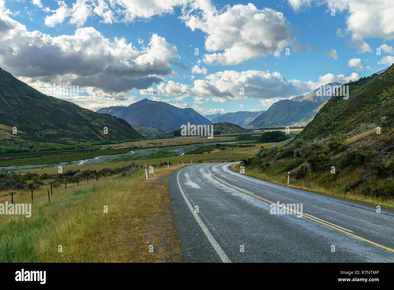 on the road in the valley between mountains, arthurs pass, new zealand
