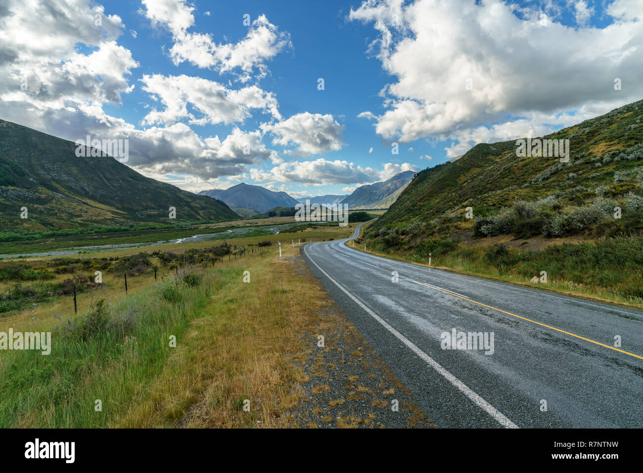 on the road in the valley between mountains, arthurs pass, new zealand
