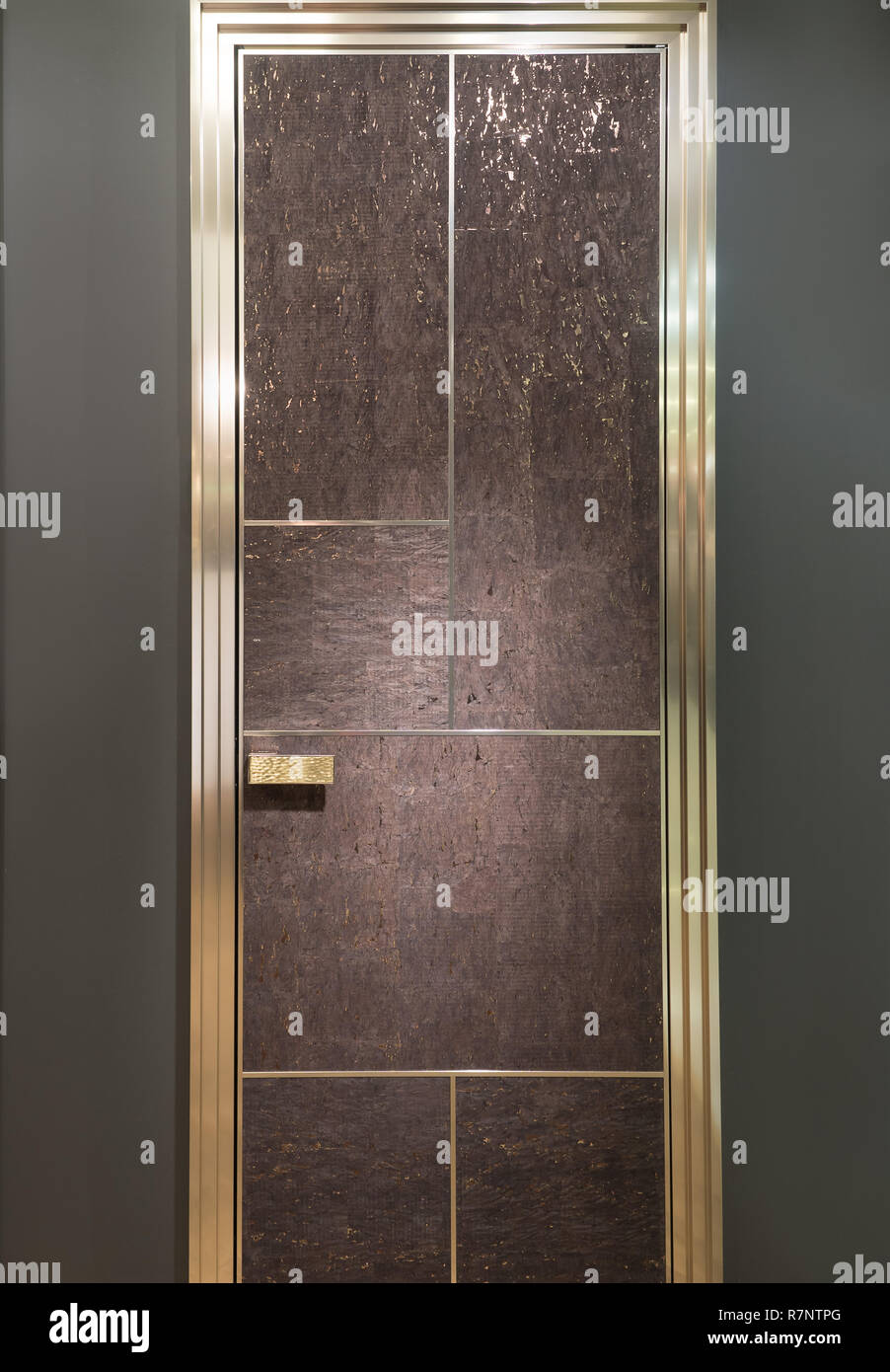 Cork rich modern door wooden door on a gray wall background Stock Photo