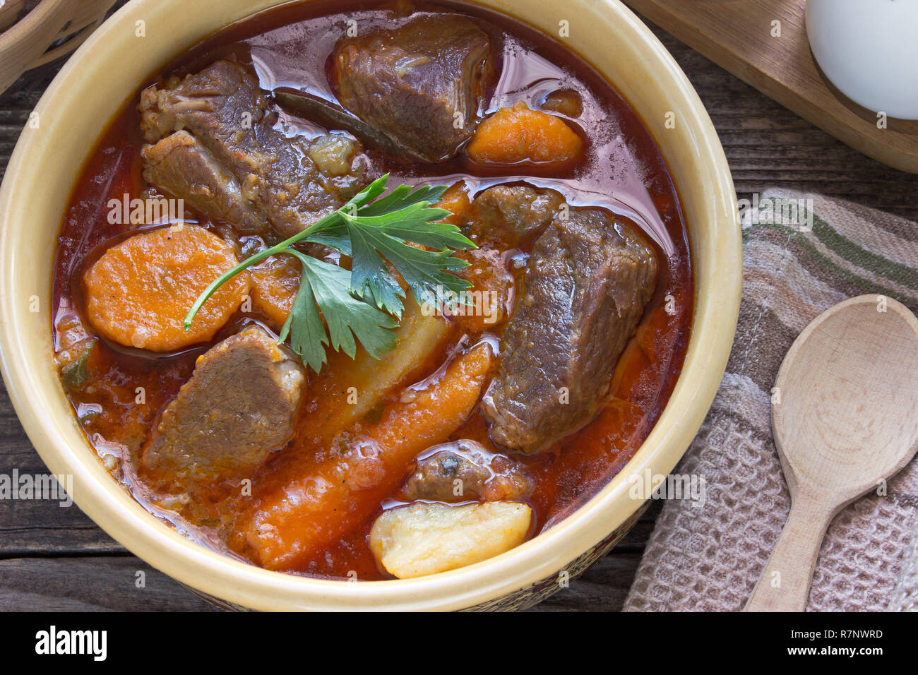 Stew with meat and vegetable in ceramic bowl on table Stock Photo