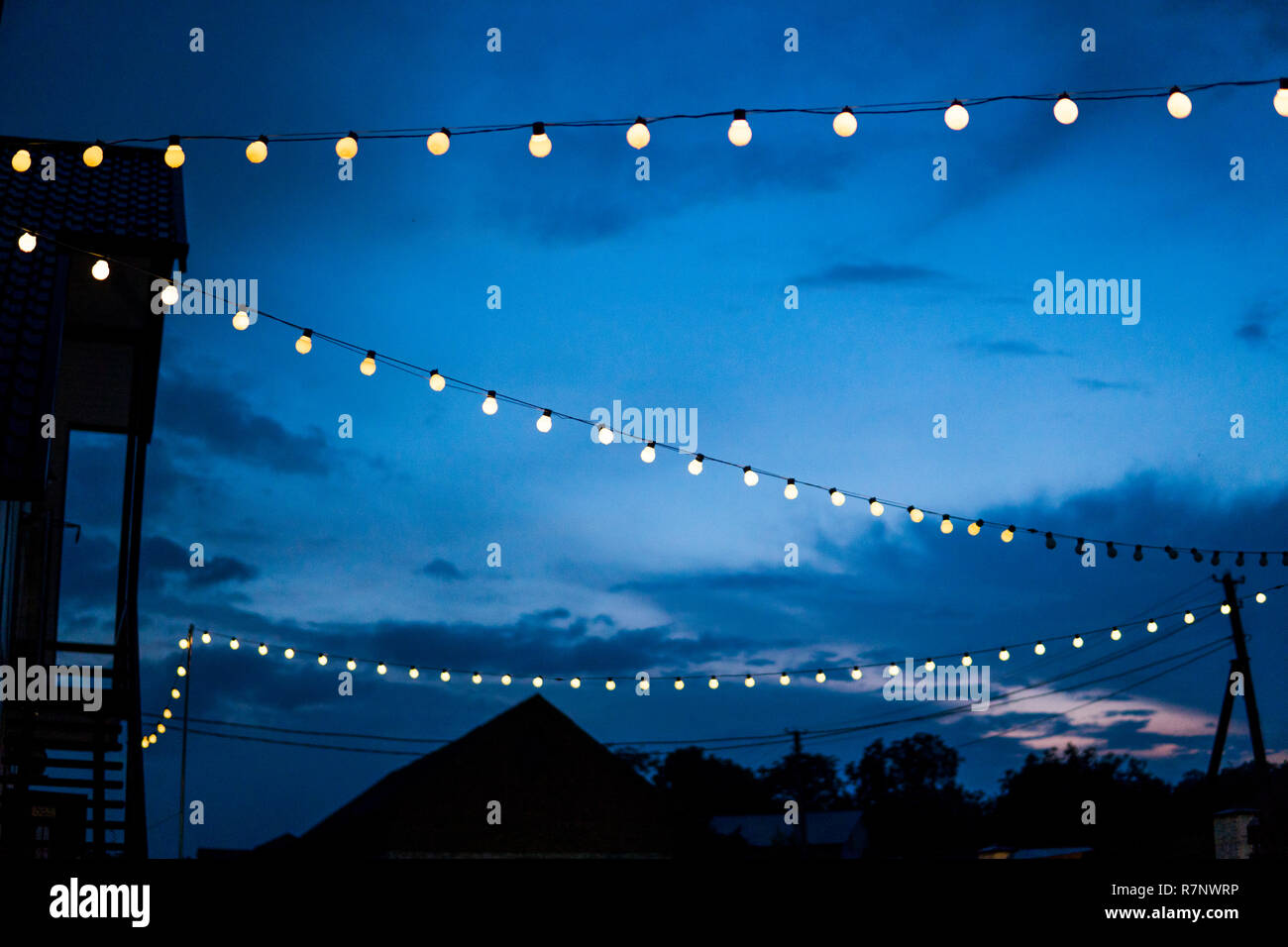 Row Of Hanging Summer Terrace Lights During Evening Small Outdoor Light Bulbs Stock Photo Alamy