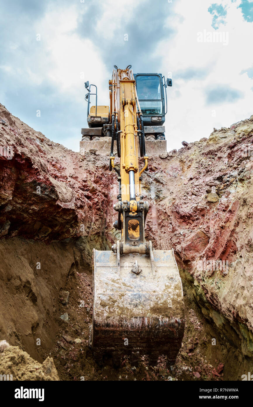 Excavator digging a trench for the pipeline. Excavation Stock Photo - Alamy