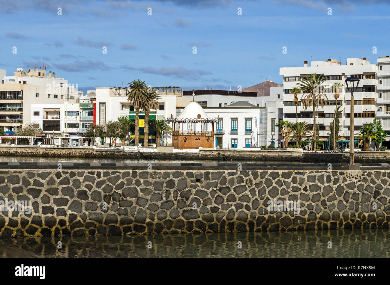 Arrecife, Spain -  November 5, 2018: View of the waterfront Avenida la Marina with the boardwalk Calle Punta de la Lagarta and a carved pavilion Stock Photo