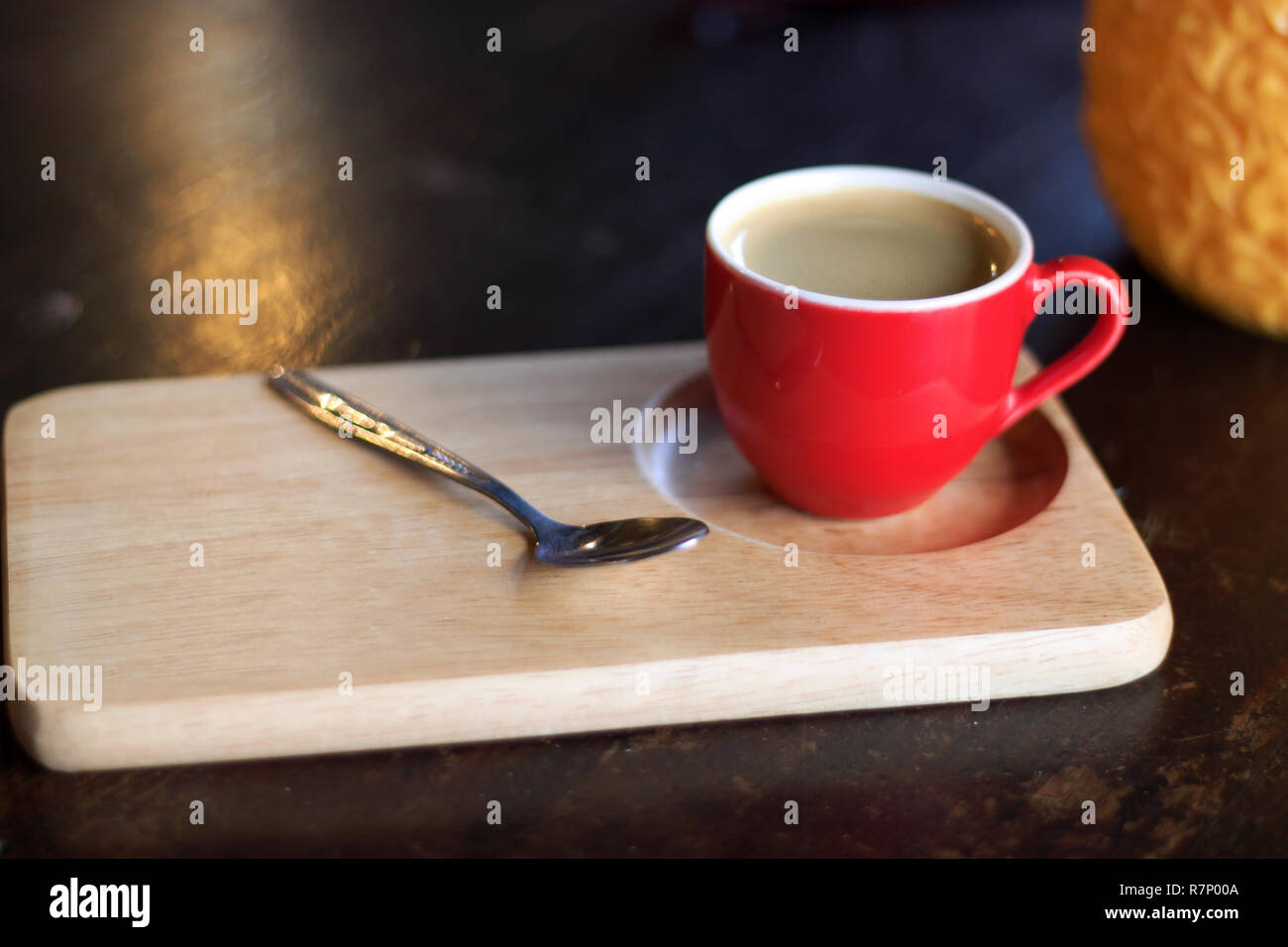 Red cup of coffee on wooden tray. Stock Photo