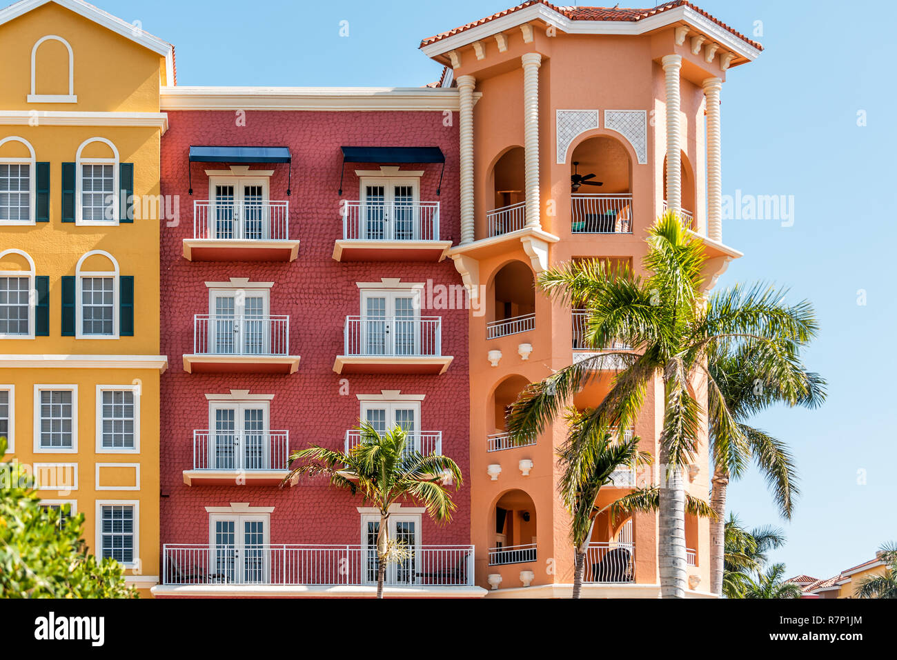 Florida condo, condominium colorful, red and orange multicolored buildings facade exterior with