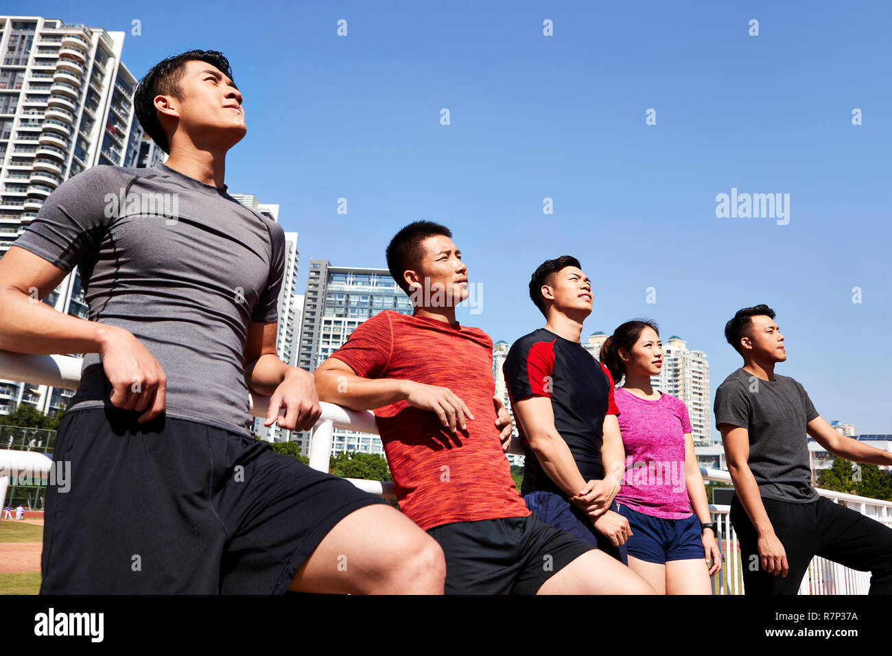 group of young asian athletes looking up at sky. Stock Photo