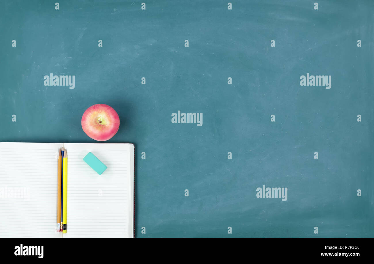 Back to school concept with paper and stationery supplies on a green ...