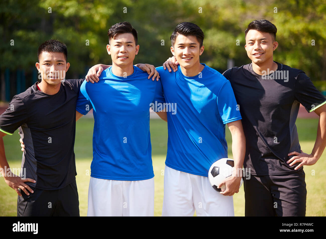 outdoor portrait of a team of young asian soccer football players Stock Photo
