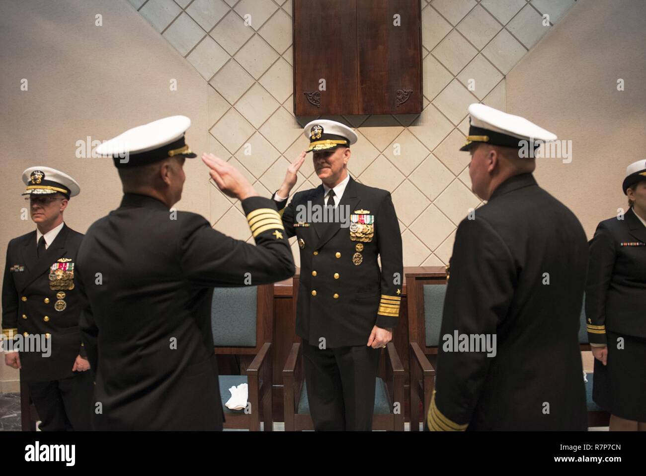 NAVAL SUPPORT ACTIVITY NAPLES, Italy (March 29, 2017) Vice Adm. Christopher Grady, commander, U.S. 6th Fleet, salutes Capt. Anthony Carullo during a change of command ceremony at the Naval Support Activity Naples Chapel, March 29, 2017. U.S. 6th Fleet, headquartered in Naples, Italy conducts the full spectrum of joint and naval operations, often in concert with allied, joint and interagency partners in order to advance U.S. national interests and security and stability in Europe and Africa. Stock Photo