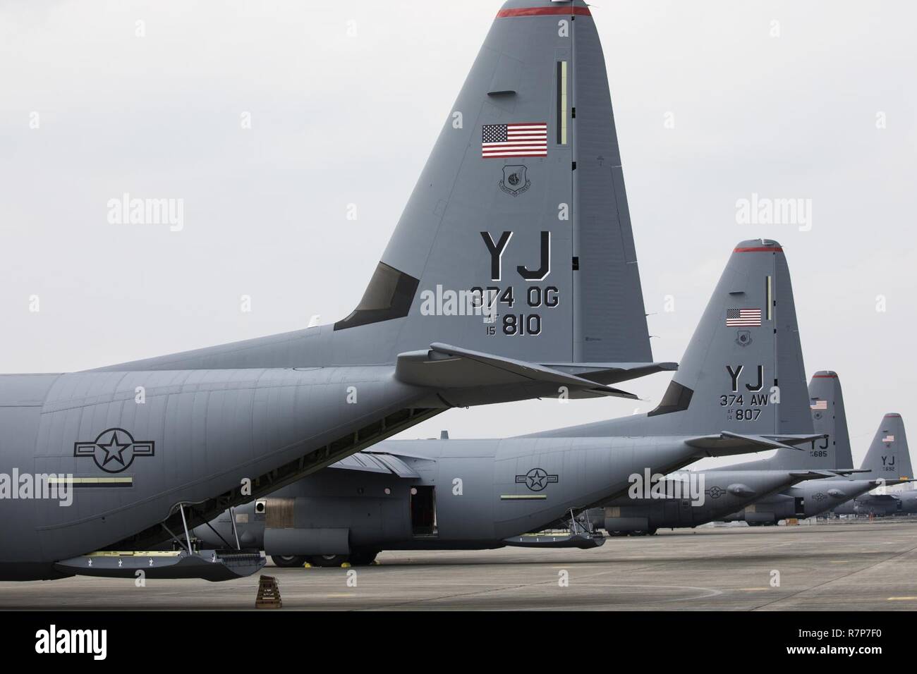 Two C-130J Super Hercules and two C-130H Hercules aircraft sit on the flightline at Yokota Air Base, Japan, March 29, 2017. Yokota is the only forward-based tactical airlift squadron in the Pacific region. They provide C-130 aircrews to conduct theater airlift, special operations, aeromedical evacuation, repatriation and humanitarian relief missions. Stock Photo