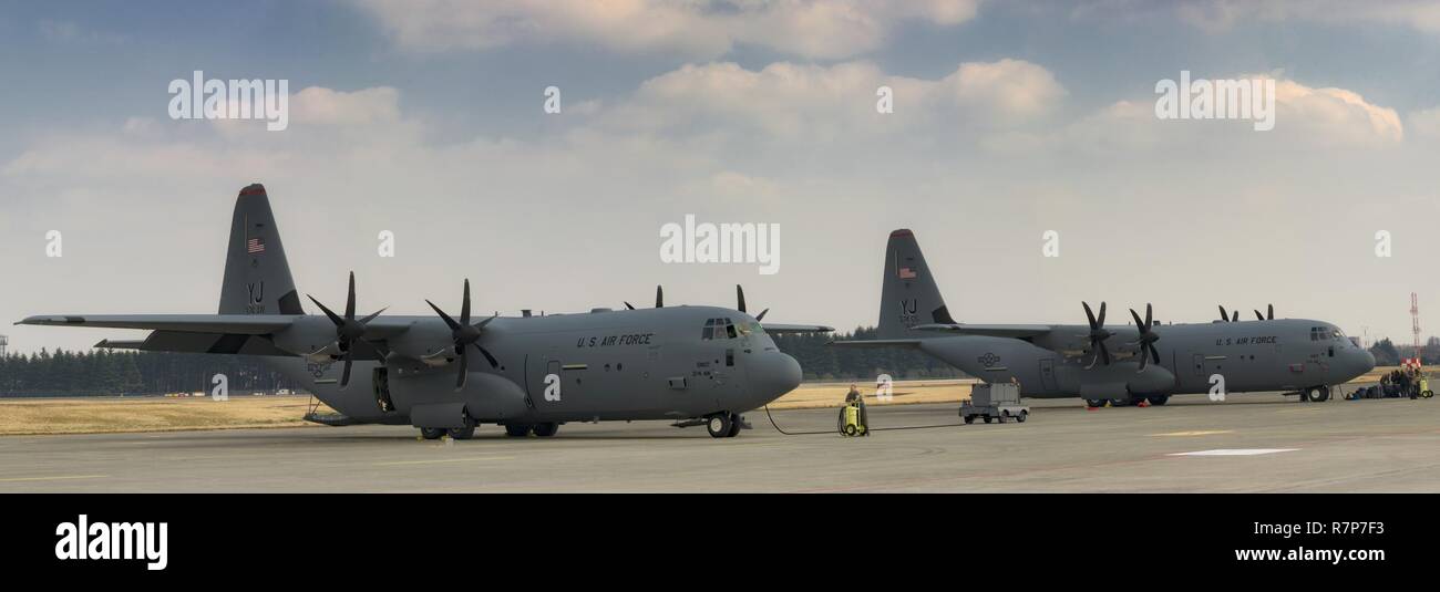 Two C-130J Super Hercules aircraft sit on the flightline at Yokota Air Base, Japan, March 29, 2017. Yokota is the only forward-based tactical airlift squadron in the Pacific region. They provide C-130 aircrews to conduct theater airlift, special operations, aeromedical evacuation, repatriation and humanitarian relief missions. Stock Photo