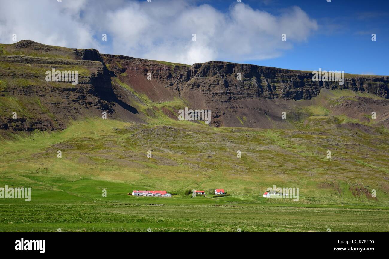 Icelandic landscape. A farm at the foot of a mountain ridge. Stock Photo