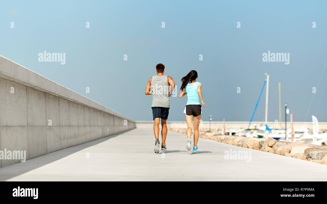 couple in sports clothes running outdoors Stock Photo - Alamy